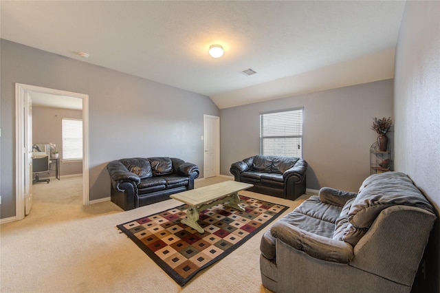 living room with lofted ceiling, baseboards, light carpet, and visible vents