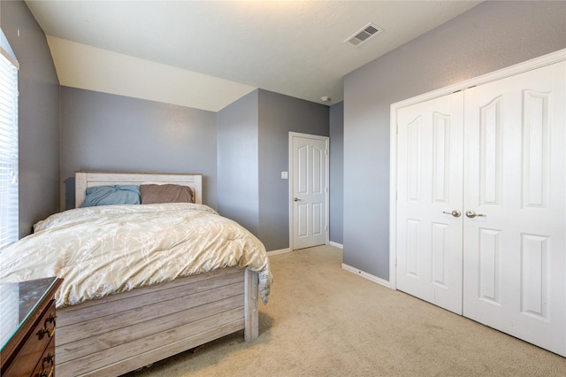 bedroom featuring light carpet, baseboards, visible vents, and a closet