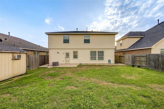 rear view of house with a patio area, a fenced backyard, and a lawn