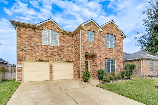 traditional home with brick siding, concrete driveway, a front yard, fence, and a garage