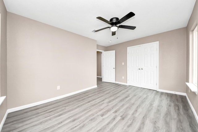 5879 Belcrest St, Houston, TX 77033 - unfurnished bedroom with a closet, wood finished floors, and ceiling fan
