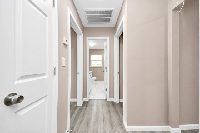 5879 Belcrest St, Houston, TX 77033 - corridor with light wood-style flooring and baseboards