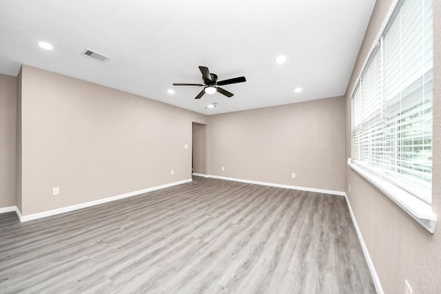5879 Belcrest St, Houston, TX 77033 - empty room with ceiling fan, wood finished floors, and recessed lighting