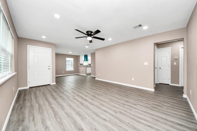 5879 Belcrest St, Houston, TX 77033 - unfurnished living room featuring a ceiling fan, wood finished floors, and recessed lighting