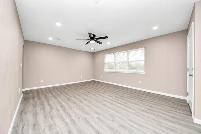 5879 Belcrest St, Houston, TX 77033 - empty room with ceiling fan, wood finished floors, and recessed lighting