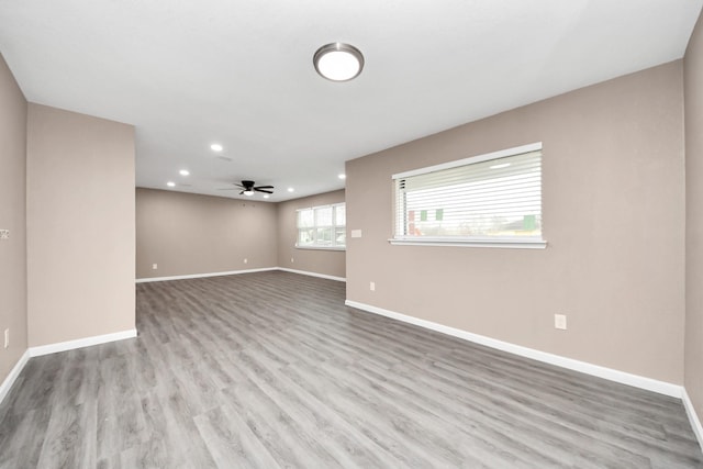 5879 Belcrest St, Houston, TX 77033 - empty room with wood finished floors, a ceiling fan, and recessed lighting