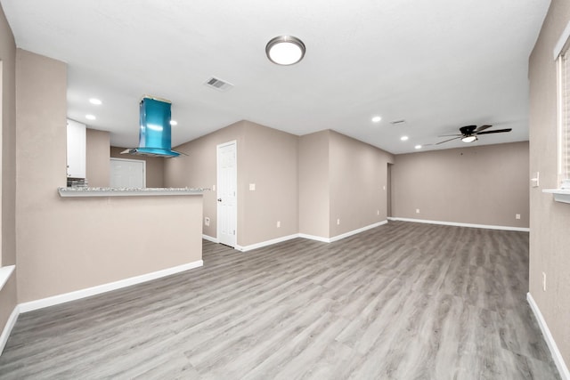 5879 Belcrest St, Houston, TX 77033 - unfurnished living room with recessed lighting, light wood finished floors, and ceiling fan