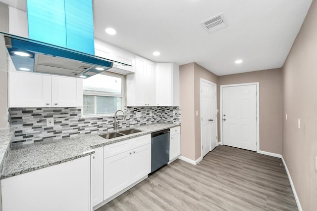 5879 Belcrest St, Houston, TX 77033 - kitchen with dishwasher, light wood finished floors, white cabinets, decorative backsplash, and light stone countertops