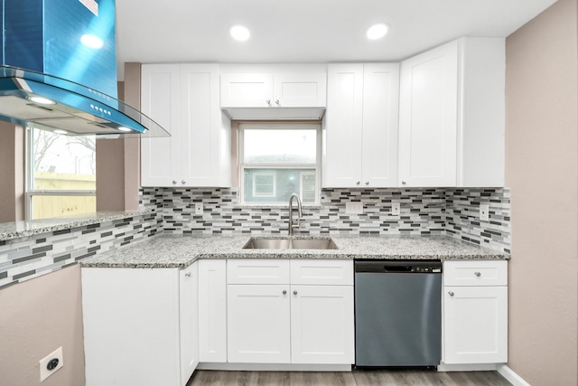 5879 Belcrest St, Houston, TX 77033 - kitchen featuring dishwasher, wall chimney range hood, light stone countertops, backsplash, and recessed lighting
