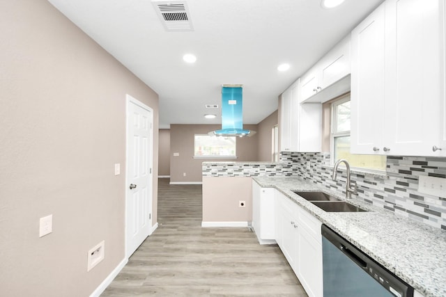5879 Belcrest St, Houston, TX 77033 - kitchen featuring dishwasher, decorative backsplash, white cabinetry, and recessed lighting