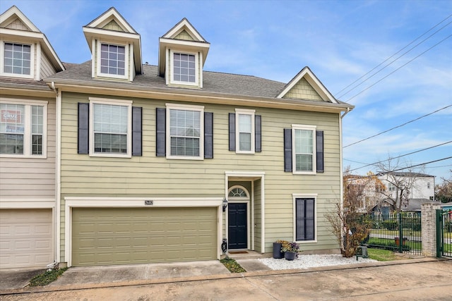 multi unit property with concrete driveway, an attached garage, and fence