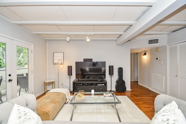 living room with hardwood / wood-style flooring, rail lighting, french doors, and beamed ceiling