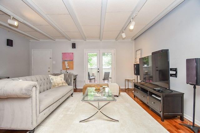 living room with beam ceiling, wood-type flooring, french doors, and track lighting