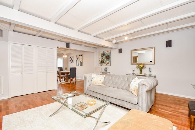 living room featuring hardwood / wood-style flooring and beamed ceiling