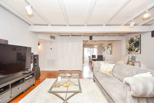 living room with ceiling fan, wood-type flooring, beamed ceiling, and track lighting