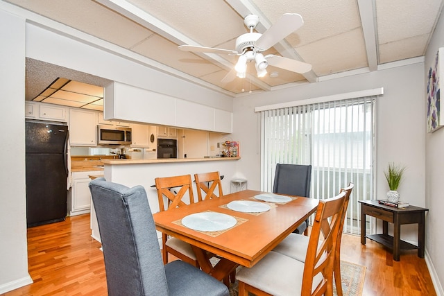 dining area with ceiling fan, a paneled ceiling, and light hardwood / wood-style floors