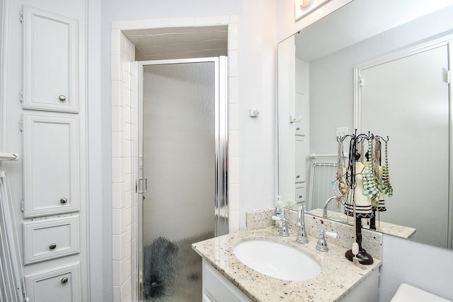 bathroom featuring vanity and an enclosed shower