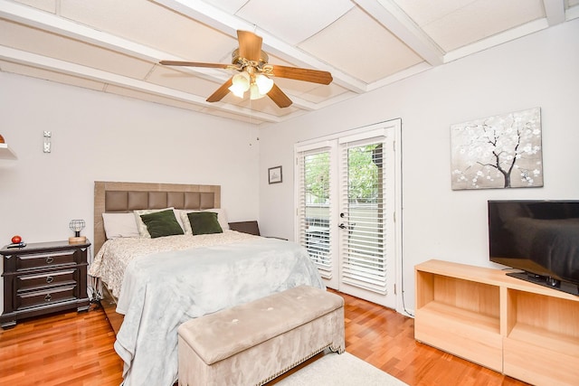 bedroom with ceiling fan, access to exterior, hardwood / wood-style floors, and beam ceiling