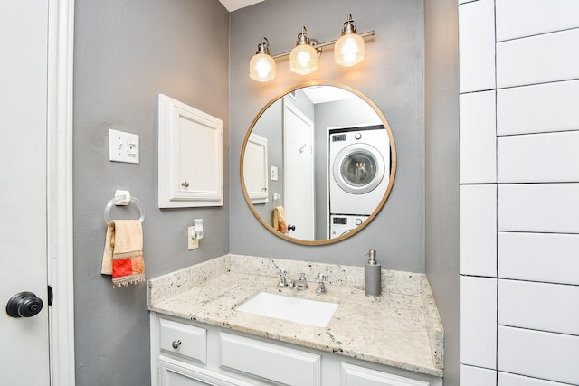 bathroom featuring vanity and stacked washer / drying machine