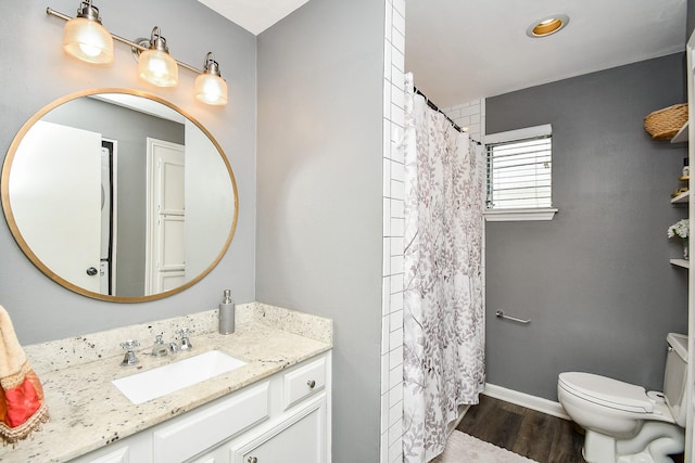 bathroom featuring hardwood / wood-style flooring, vanity, toilet, and walk in shower