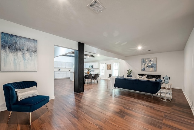 living room with dark hardwood / wood-style flooring