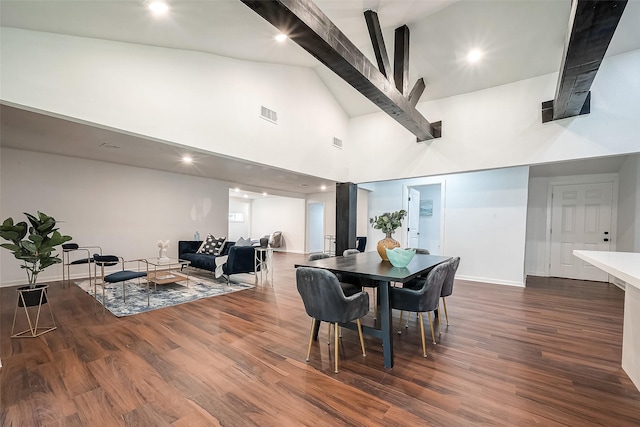 dining area with high vaulted ceiling and dark hardwood / wood-style flooring