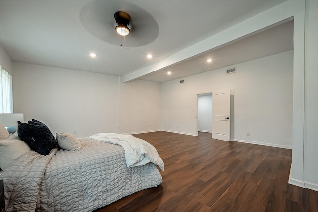 bedroom with dark wood-type flooring, ceiling fan, and beamed ceiling