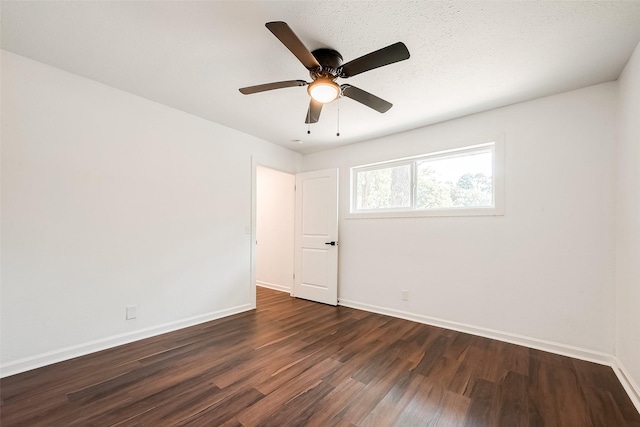 empty room with dark wood-type flooring and ceiling fan