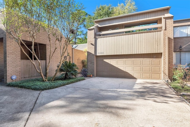 view of front of home with a garage and a balcony