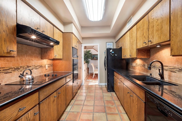 kitchen featuring sink, backsplash, black appliances, and light tile patterned floors