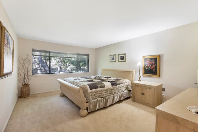 bedroom featuring light colored carpet