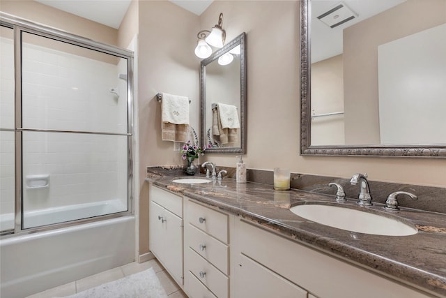 bathroom featuring bath / shower combo with glass door, tile patterned floors, and vanity