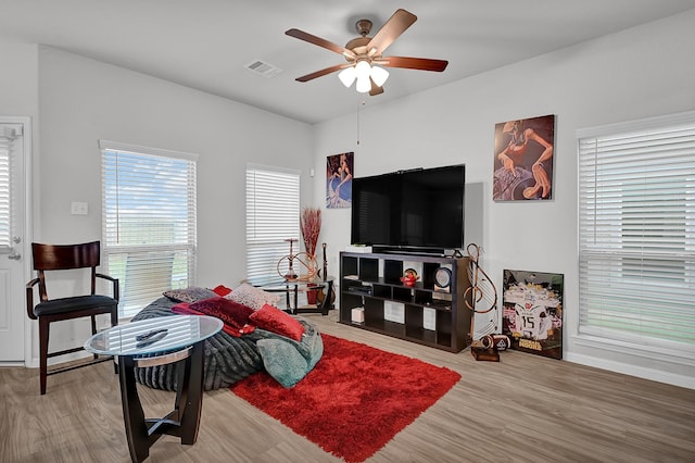 living room featuring hardwood / wood-style floors and ceiling fan