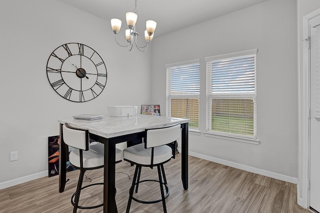 dining space featuring a chandelier and light hardwood / wood-style flooring