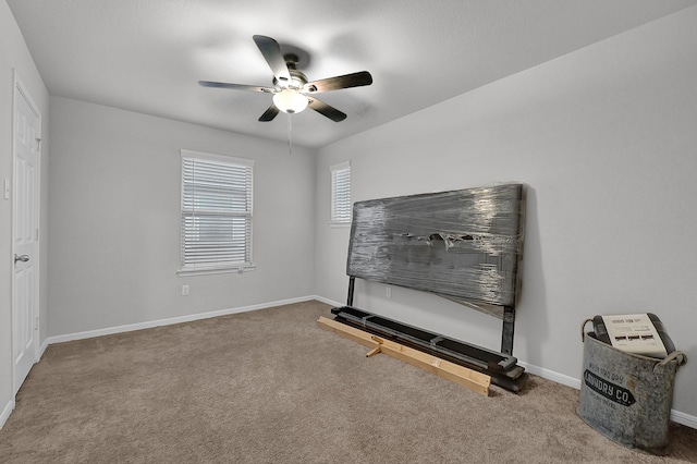 interior space featuring carpet floors and ceiling fan