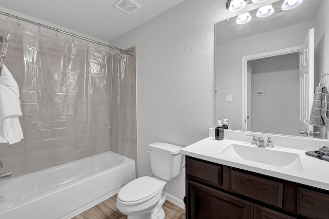 full bathroom featuring vanity, hardwood / wood-style flooring, shower / bath combination with curtain, and toilet