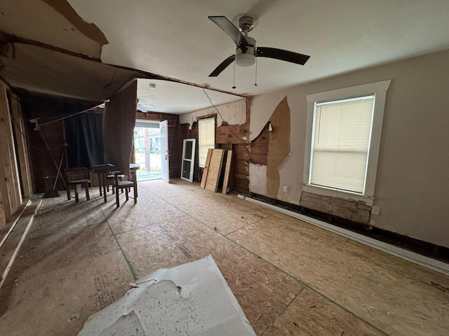 unfurnished living room with ceiling fan