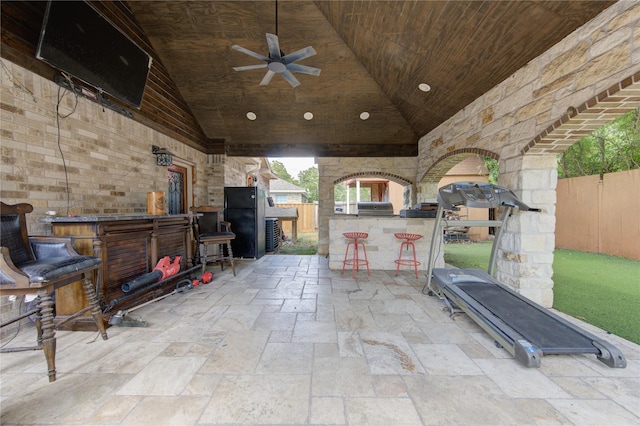 view of patio featuring a bar, a grill, and ceiling fan