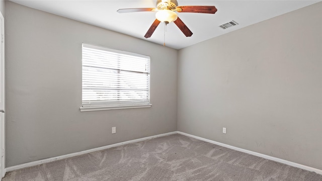 empty room featuring light colored carpet and ceiling fan