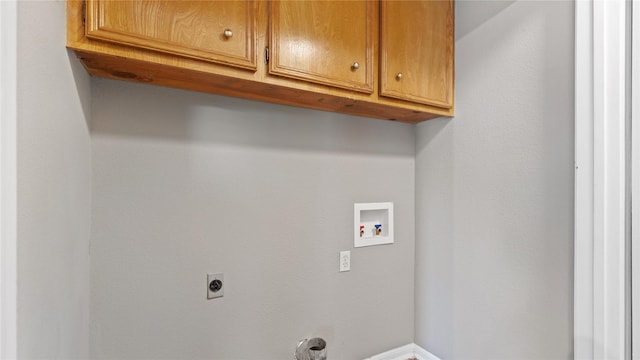 laundry area with electric dryer hookup, hookup for a washing machine, and cabinets