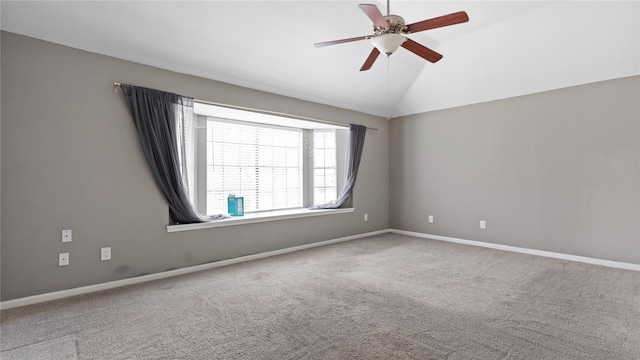 empty room with lofted ceiling, carpet floors, and ceiling fan