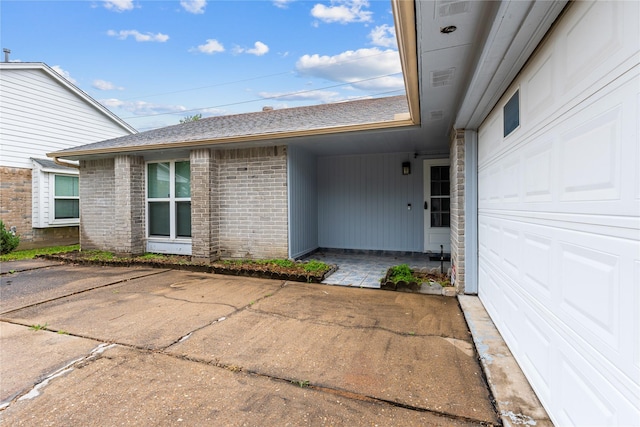 view of exterior entry with a garage