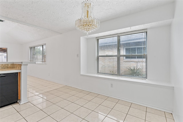 unfurnished dining area featuring light tile patterned flooring, a textured ceiling, and an inviting chandelier