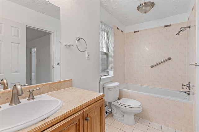 full bathroom featuring vanity, toilet, tile patterned flooring, and a textured ceiling