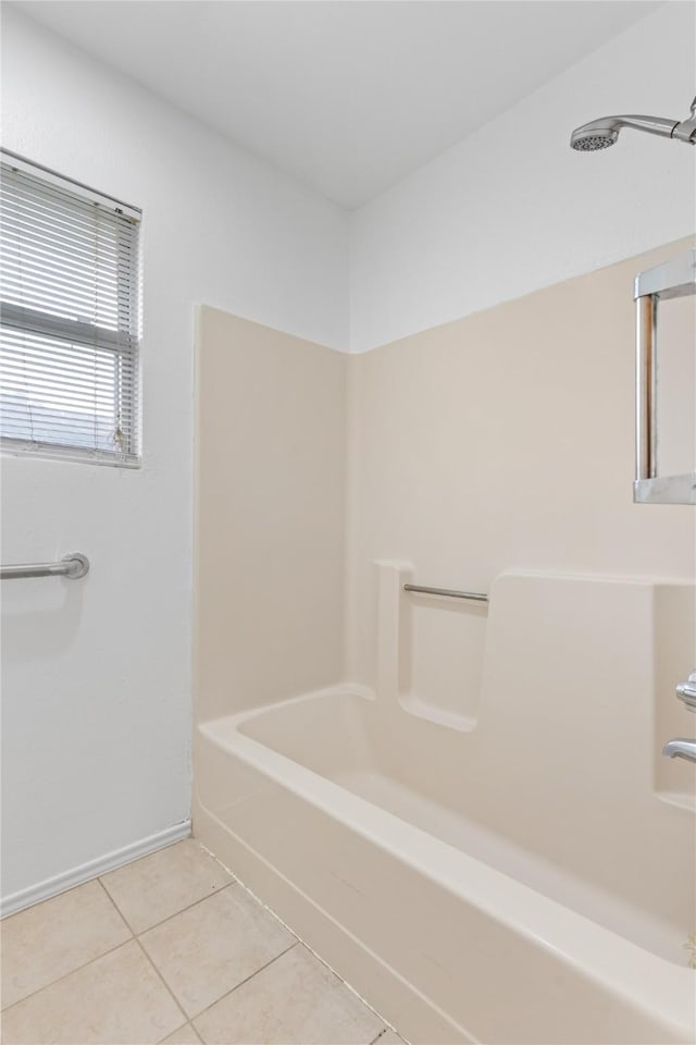 bathroom featuring tile patterned flooring and  shower combination