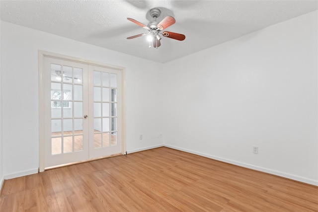 spare room with ceiling fan, light hardwood / wood-style flooring, a textured ceiling, and french doors