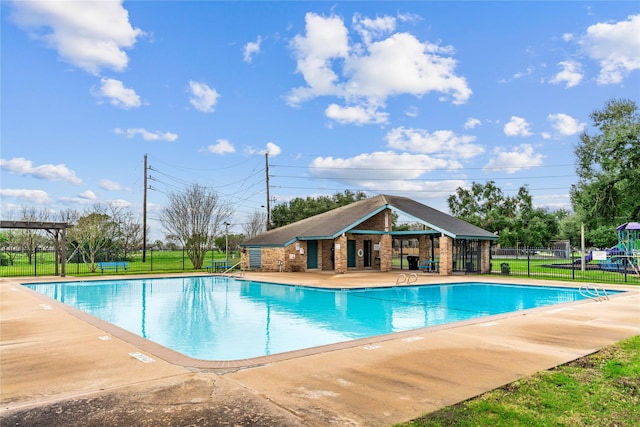 view of pool with a patio and an outdoor structure