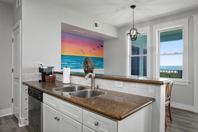 kitchen featuring sink, white cabinetry, hanging light fixtures, a water view, and stainless steel dishwasher