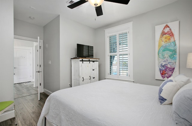 bedroom featuring hardwood / wood-style floors and ceiling fan