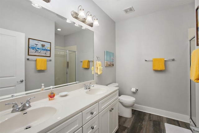 bathroom with vanity, wood-type flooring, toilet, and walk in shower